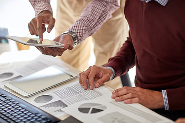 Image showing businessmen with tablet pc and charts at office