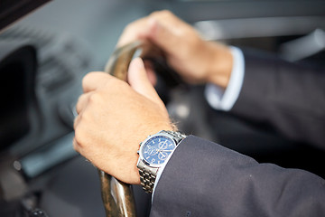 Image showing senior businessman hands driving car