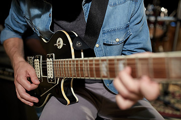 Image showing man playing guitar at studio rehearsal