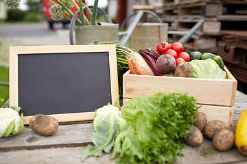 Image showing close up of vegetables with chalkboard on farm