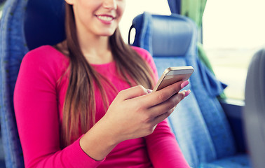 Image showing close up of woman in travel bus with smartphone