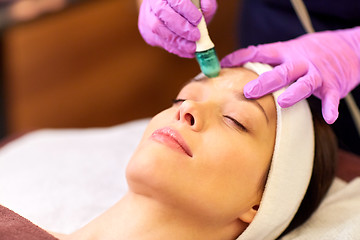 Image showing woman having microdermabrasion facial treatment