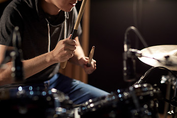 Image showing male musician playing drums and cymbals at concert