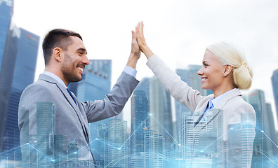 Image showing businessman and businesswoman making high five