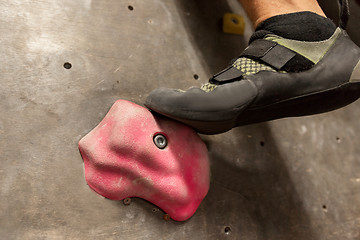 Image showing foot of man exercising at indoor climbing gym