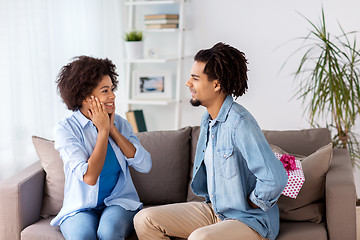 Image showing happy couple with gift box at home