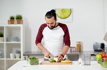 Image showing man with blender and fruit cooking at home kitchen