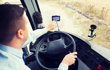 Image showing close up of bus driver driving with gps navigator