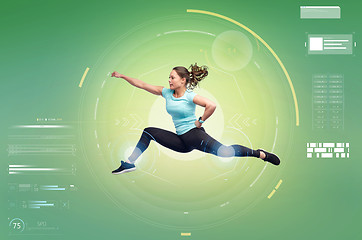 Image showing happy sporty young woman jumping in fighting pose