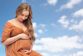 Image showing happy pregnant woman touching her big belly