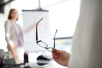 Image showing businessman with glasses at presentation in office