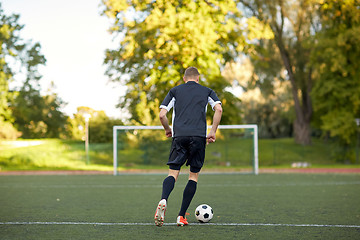 Image showing soccer player playing with ball on football field