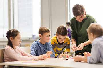 Image showing happy children building robots at robotics school