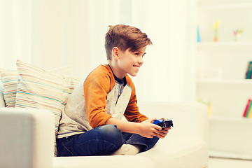 Image showing happy boy with joystick playing video game at home