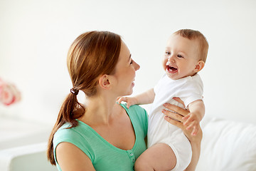 Image showing happy young mother with little baby at home