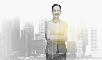 Image showing smiling businesswoman over city buildings