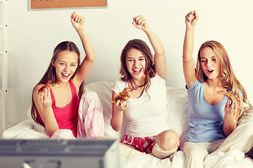 Image showing happy friends or teen girls eating pizza at home