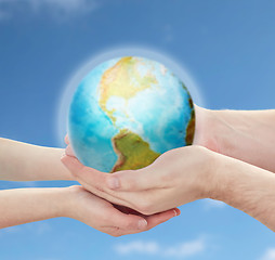 Image showing child and father hands holding earth planet