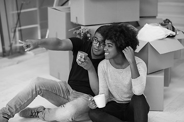 Image showing African American couple relaxing in new house