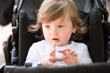 Image showing baby girl sitting in the pram