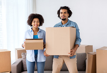 Image showing happy couple with boxes moving to new home