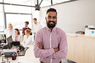 Image showing happy indian man over creative team in office