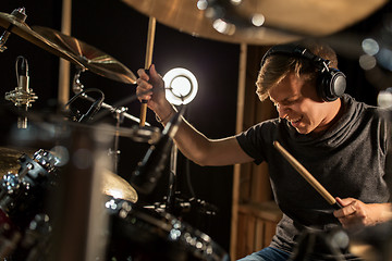 Image showing male musician playing drums and cymbals at concert