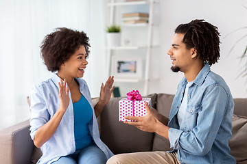 Image showing happy couple with gift box at home