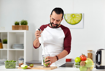 Image showing man with blender cooking food at home kitchen