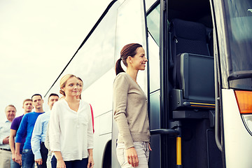 Image showing group of happy passengers boarding travel bus