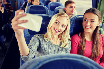 Image showing women taking selfie by smartphone in travel bus