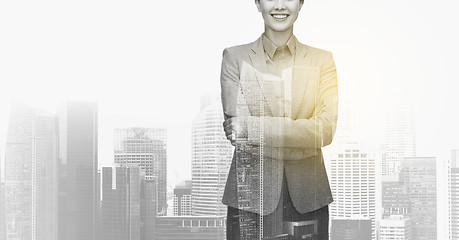 Image showing smiling businesswoman over city buildings