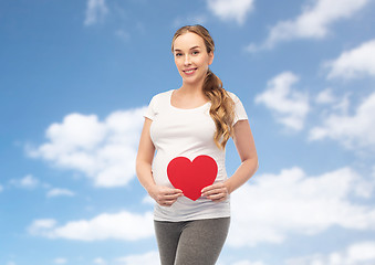 Image showing happy pregnant woman with red heart