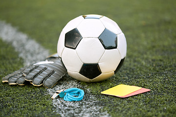 Image showing ball, gloves, whistle and cards on soccer field