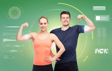 Image showing happy sportive man and woman showing biceps power