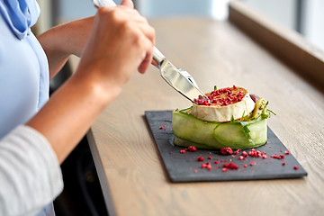 Image showing woman eating goat cheese salad at restaurant