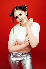 Image showing young pretty emitonal posing teenage girl on bright red background, happy smiling lifestyle people concept 