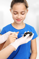 Image showing Examine blood sugar levels. Prevention of diabetes in children Diabetes, child explores sugar levels Examine your child sugar. Blood sugar testing, child finger lancet punctures 