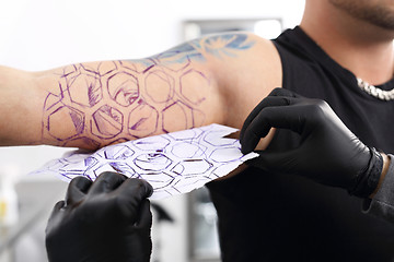 Image showing Color tattoo. Tatoo drawing on his shoulder.