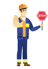 Image showing Asian builder holding stop road sign.