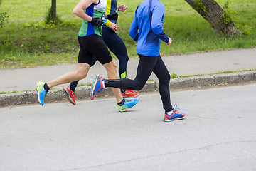 Image showing Marathon running race three runners on city road