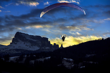 Image showing Paraglider flies in the blue winter sky