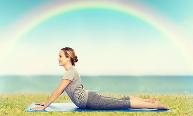 Image showing woman making yoga in dog pose on mat