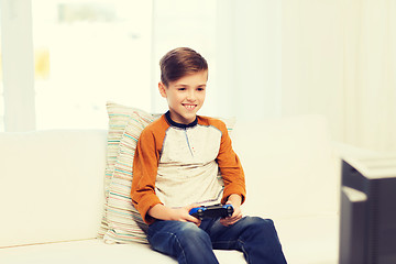 Image showing happy boy with joystick playing video game at home