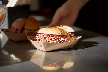 Image showing hamburger in disposable paper plate on table