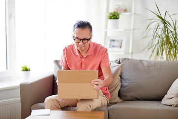 Image showing man opening parcel box at home