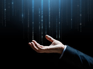 Image showing close up of businessman hand with binary code