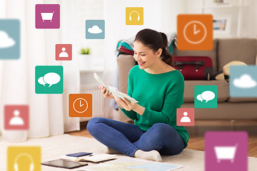 Image showing happy woman with money and travel map at home