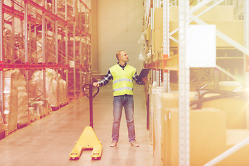 Image showing man with loader and clipboard at warehouse