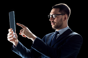 Image showing businessman in suit with transparent tablet pc